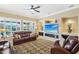 Living room with leather furniture and stone fireplace at 12975 W Andrew Ln, Peoria, AZ 85383