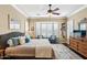 Main bedroom with a king-size bed, bay window, and two comfy armchairs at 12975 W Andrew Ln, Peoria, AZ 85383