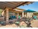 Relaxing patio with covered seating area, outdoor furniture, and a hot tub at 12975 W Andrew Ln, Peoria, AZ 85383