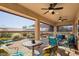 Spacious covered patio with comfortable seating and ceiling fans at 12975 W Andrew Ln, Peoria, AZ 85383