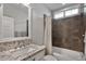 Well-lit bathroom with a granite vanity and a bathtub with tile surround at 1364 E Elysian Pass, Queen Creek, AZ 85140