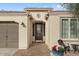 Charming front entryway with beautiful brickwork, potted flowers, and seating area at 1364 E Elysian Pass, Queen Creek, AZ 85140