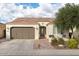 Charming single-story home featuring a tile roof, landscaped front yard, and attached two-car garage at 1364 E Elysian Pass, Queen Creek, AZ 85140