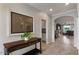 Bright hallway featuring tile floors, neutral walls, and a decorative console table at 1364 E Elysian Pass, Queen Creek, AZ 85140