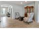 Hallway with tile flooring and decorative chairs and antique wood cabinet at 1364 E Elysian Pass, Queen Creek, AZ 85140