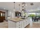 Open kitchen featuring granite counters, island with seating, and stainless steel range at 1364 E Elysian Pass, Queen Creek, AZ 85140