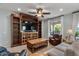 Inviting living room with custom built-ins, ceiling fan and natural light at 1364 E Elysian Pass, Queen Creek, AZ 85140