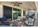 Inviting covered patio with ceiling fans, outdoor seating and lush green landscape at 1364 E Elysian Pass, Queen Creek, AZ 85140