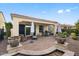 Covered outdoor patio with ample seating, BBQ grill and low-maintenance landscaping at 1364 E Elysian Pass, Queen Creek, AZ 85140