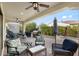 Outdoor patio with ceiling fans, comfortable seating, grill, and lush landscaping at 1364 E Elysian Pass, Queen Creek, AZ 85140