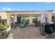 Covered patio with ample seating, lush landscaping, BBQ and outdoor dining space at 1364 E Elysian Pass, Queen Creek, AZ 85140