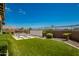 Artificial turf backyard with seating area and wall at 13713 W Harvest Ave, Litchfield Park, AZ 85340