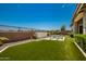 Artificial turf backyard with seating area and wall at 13713 W Harvest Ave, Litchfield Park, AZ 85340