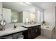 Elegant bathroom with soaking tub and walk-in shower at 13713 W Harvest Ave, Litchfield Park, AZ 85340