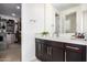 Modern bathroom with a vanity and walk-in closet access at 13713 W Harvest Ave, Litchfield Park, AZ 85340