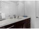 Modern bathroom with dark vanity and a large mirror at 13713 W Harvest Ave, Litchfield Park, AZ 85340