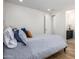 Guest bedroom with a gray upholstered bed and an ensuite bathroom at 13713 W Harvest Ave, Litchfield Park, AZ 85340