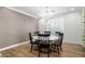 Dining room with round table, chandelier, and wood floors at 13713 W Harvest Ave, Litchfield Park, AZ 85340