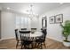 Elegant dining room with a round table and chandelier at 13713 W Harvest Ave, Litchfield Park, AZ 85340