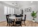 Formal dining room with round table and black chairs at 13713 W Harvest Ave, Litchfield Park, AZ 85340