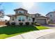 Two-story house with stone accents and a two-car garage at 13713 W Harvest Ave, Litchfield Park, AZ 85340