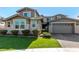 Two-story house with stone accents and a two-car garage at 13713 W Harvest Ave, Litchfield Park, AZ 85340