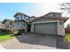 Two-story house with stone accents and a two-car garage at 13713 W Harvest Ave, Litchfield Park, AZ 85340