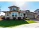 Two-story house with stone accents and a two-car garage at 13713 W Harvest Ave, Litchfield Park, AZ 85340