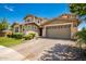 Two-story house with stone accents and a paved driveway at 13713 W Harvest Ave, Litchfield Park, AZ 85340