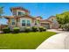 Two-story house with stone accents and a landscaped lawn at 13713 W Harvest Ave, Litchfield Park, AZ 85340