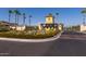 Gated community entrance with palm trees at 13713 W Harvest Ave, Litchfield Park, AZ 85340