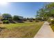 Landscaped green space with a walkway at 13713 W Harvest Ave, Litchfield Park, AZ 85340