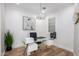 Bright home office with glass desk and modern light fixture at 13713 W Harvest Ave, Litchfield Park, AZ 85340