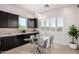 Kitchen breakfast nook with dark cabinets and glass table at 13713 W Harvest Ave, Litchfield Park, AZ 85340