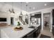 Modern kitchen with island, stainless steel appliances, and dark cabinetry at 13713 W Harvest Ave, Litchfield Park, AZ 85340