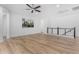 Bright loft area with wood-look floors and ceiling fan at 13713 W Harvest Ave, Litchfield Park, AZ 85340