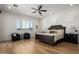 Main bedroom with dark wood furniture and ceiling fan at 13713 W Harvest Ave, Litchfield Park, AZ 85340