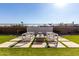 Backyard patio with modern fire pit and seating area at 13713 W Harvest Ave, Litchfield Park, AZ 85340