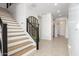 Modern staircase with wood steps and metal railing at 13713 W Harvest Ave, Litchfield Park, AZ 85340