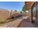 Landscaped backyard with gravel and brick patio at 14413 N 91St St, Scottsdale, AZ 85260