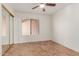 Second bedroom with large window and ceiling fan at 14413 N 91St St, Scottsdale, AZ 85260