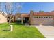 Spanish style home with a two car garage and well-manicured lawn at 14413 N 91St St, Scottsdale, AZ 85260