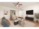 Living room with staged furniture and a large TV at 14413 N 91St St, Scottsdale, AZ 85260