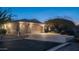 Attractive home exterior at dusk, showcasing a two-car garage and well-lit driveway at 14845 S 31St Way, Phoenix, AZ 85048