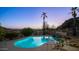 Relaxing pool area at dusk, with mountain views and palm trees at 14845 S 31St Way, Phoenix, AZ 85048