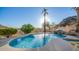 Inviting pool with a waterfall, mountain views and palm trees at 14845 S 31St Way, Phoenix, AZ 85048