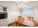 Charming dining area featuring a round wooden table and four chairs at 150 S Windsor -- # F87, Mesa, AZ 85204