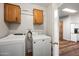 Laundry room with washer, dryer, and upper cabinets at 150 S Windsor -- # F87, Mesa, AZ 85204