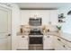 Modern kitchen with white cabinets and stainless steel appliances at 1537 E Caballero Dr, Casa Grande, AZ 85122