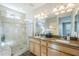 Bathroom boasts double sinks, a shower, and wood cabinets at 1572 E Artemis Trl, Queen Creek, AZ 85140